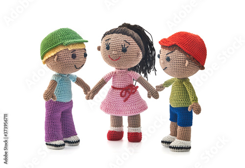 Knitted toys boys and girl on a white background © Andrey Zyk