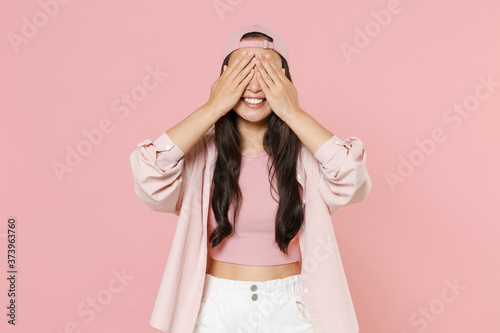 Cuadros en Lienzo Smiling young asian woman girl in casual clothes cap posing isolated on pastel pink background studio portrait