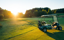Golf Cart Or Golf Club Cars In A Beautiful Golf Course. Green Golf And Light Of Sun To Beauty View For Player To Happy.