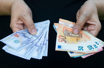 Euro and dollar banknotes in hands. Economy concept, currency exchange