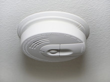 Close Up Of A Ceiling Mount White Smoke Detector Used In Homes.