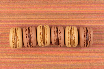 Sticker - Six coffee and chocolated flavoured macaroons on vinyl background