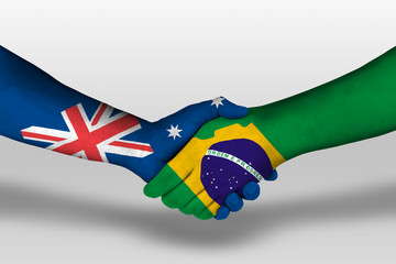 Handshake between brazil and australia flags painted on hands, illustration with clipping path.