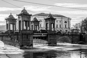 Wall Mural - Winter cityscape of St. Petersburg with the freezing Fontanka river and a view of the Lomonosov bridge