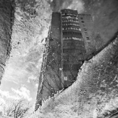 Wall Mural - Brick apartment building reflected in a muddy puddle