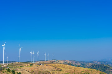 Wind turbine on the mountain with blue sky natural background.