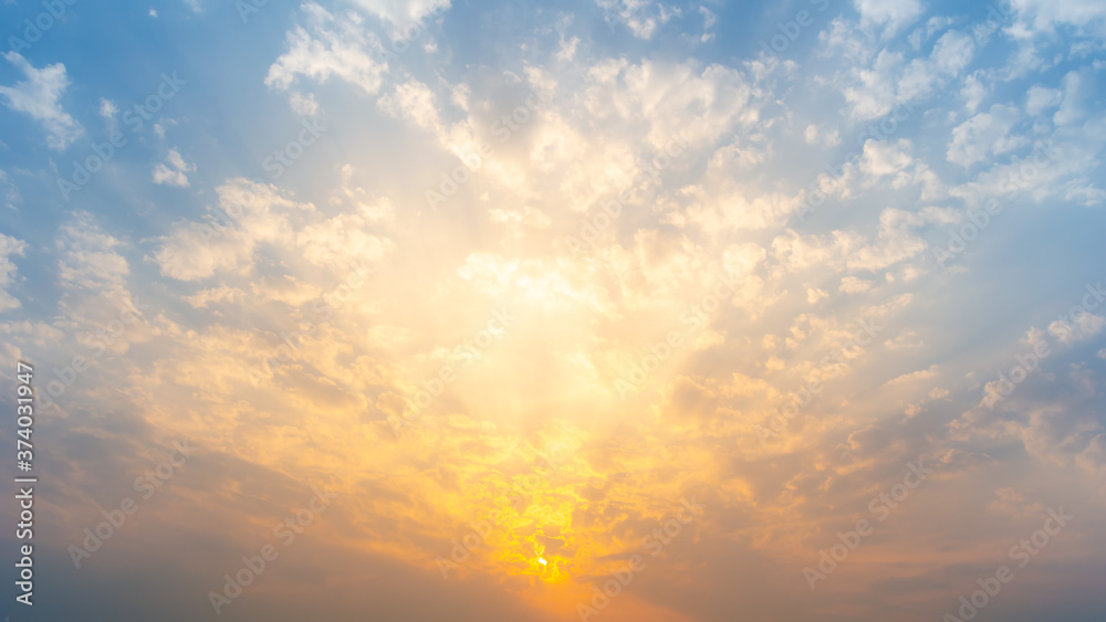 Beautiful Vivid sky painted by the sun leaving bright golden shades.Dense clouds in twilight sky in winter evening.Image of cloud sky on evening time.Evening Vivid  sky with clouds. - obrazy, fototapety, plakaty 