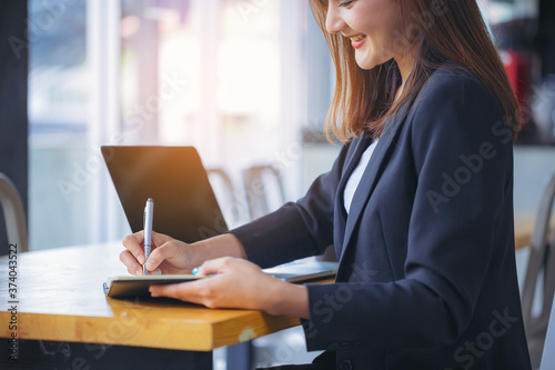 Cuadros en Lienzo Businesswoman secretary writing information, boss order in notebook before meeting