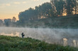 © nikolay_alekhin - Summer time. Morning dawn over the river in a hazy, thoughtful haze. Beautiful view of the forest and river covered with fog early in the morning.