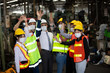 © FotoArtist - Closeup on Industrial Engineers hands raise up  as a team unity with Factory Worker. They Work at the Heavy Industry Manufacturing Facility.