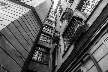 The courtyard of an old apartment building in St. Petersburg with yellow shabby walls