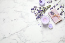 Cosmetic Products And Lavender Flowers On White Marble Table, Flat Lay. Space For Text