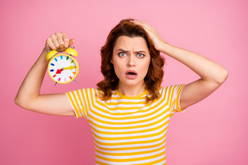 Wall Mural - Close-up portrait of her she nice-looking attractive lovely worried wavy-haired girl holding in hand bell clock oversleep bedtime oops isolated over pink pastel color background