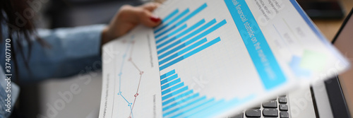 Fotografía Woman holds analytics of commercial indicators in business