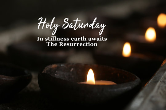 Wall Mural -  - Holly week concept with candle and inspirational quote - Holy Saturday. In stillness earth awaits The Resurrection. On dark background of burning candles in traditional bowl ceramic in the church.