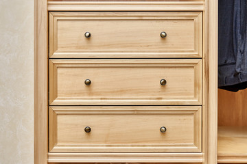 detail of wardrobe with wooden furniture in dressing room. frontal view