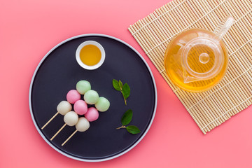 Japanese tea and sweet dumplings Dango on plate, top view