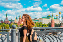 Portrait Of A Beautiful Young Female Tourist With A View Of The Kremlin In Moscow, Russia