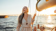 © Artem Varnitsin - Happy mature woman standing on a yacht at sunset and looking away