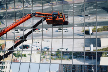 People cleaning windows of the building