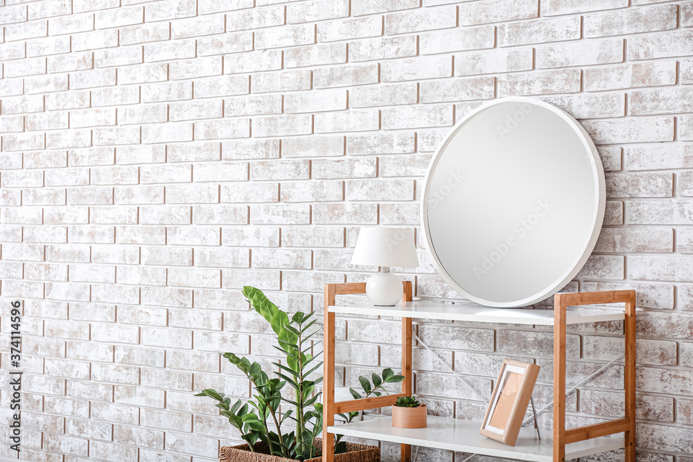Stylish interior of room with shelving unit and mirror