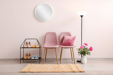 Poster - Stylish interior of hallway with shoe stand, chairs and mirror