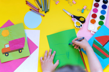 School supplies, stationery on yellow background - space for caption. Child ready to draw with pencils and make application of colored paper. Top view.