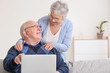 © Pixel-Shot - Senior couple with laptop at home