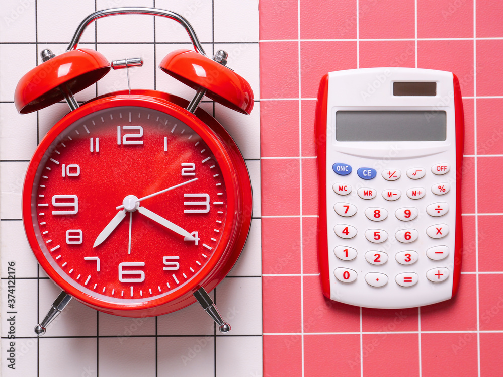 Alarm clock with calculator on color background