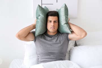 Canvas Print - Young man suffering from insomnia in bedroom