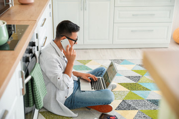 Wall Mural - Man with laptop booking room in hotel online at home