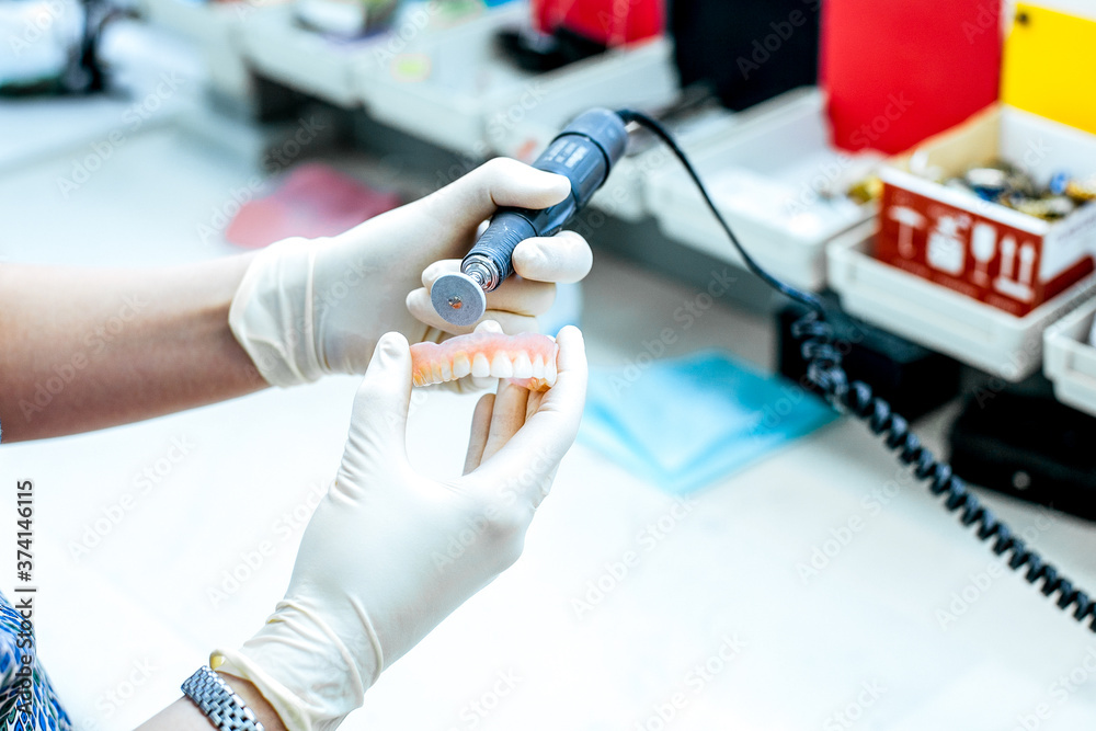 Dental technician working the partial denture