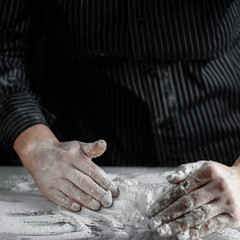 Sticker - Flour on a wooden table surrounded by female hands with free space for an advertising product