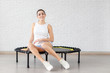Relaxed woman sitting on trampoline