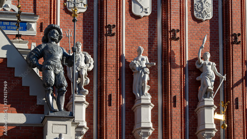 Riga. Buildings and cozy streets of the old city. Variegated facades, stone paving stones. Cafes and restaurants. People walk the streets in the evening. Latvia. Summer 2020