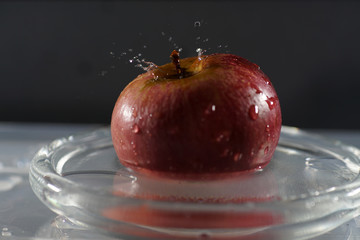 Poster - Closeup shot of a red apple with water droplets on it