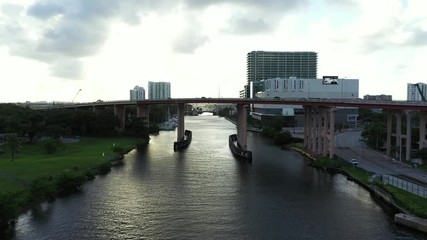 Wall Mural - Aerial drone flying under Dolphin Expressway 836 Miami River 4k