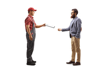 Canvas Print - Full length profile shot of a male courier handing a document to a bearded man