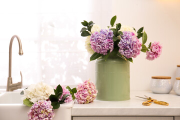 Canvas Print - Bouquet with beautiful hydrangea flowers in can and scissors on light countertop