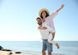 © New Africa - Happy young couple having fun at beach near sea. Honeymoon trip