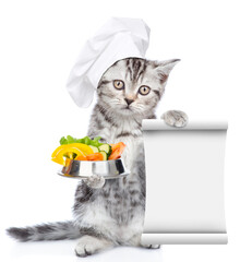 Poster - Kitten wearing chef's hat holds bowl of the vegetables and empty list. isolated on white background