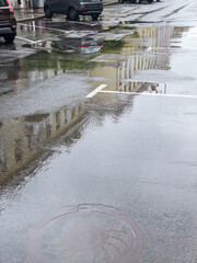 Wall Mural - cars parked on a wet street after heavy rains in downtown