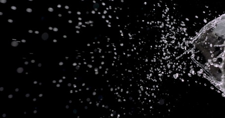  macro shot of water spattering against a black background.