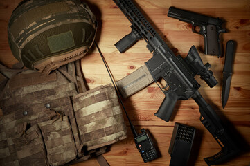 Wall Mural - Weapons and military equipment for army, Assault rifle gun and pistol on wooden background.