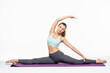 © dianagrytsku - Yoga pose standing class. Slim fit girl involved in stretching sports. Work on yourself exercise fitness exercises for women. Asana relaxation harmony balance. Twine gymnastics.