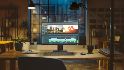 Poster - Shot of a Desktop Computer Standing on a Desk with Professional Video Montage Editing Software. In the Background Warm Evening Lighting and Open Space Studio with City Window View.