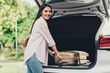 © deagreez - Photo of positive girl have summer time vacation put suitcase car trunk ready travel airport air flight camp in city center outdoors