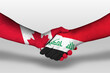 Handshake between iraq and canada flags painted on hands, illustration with clipping path.