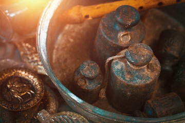 Wall Mural - Old rusty iron weights and a wooden flute in a metal plate with other retro furniture on the countertop at antique bazaar. Shopping at bazaar concept.