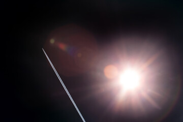 Wall Mural - dark background. rocket contrail. bright sun in outer space.